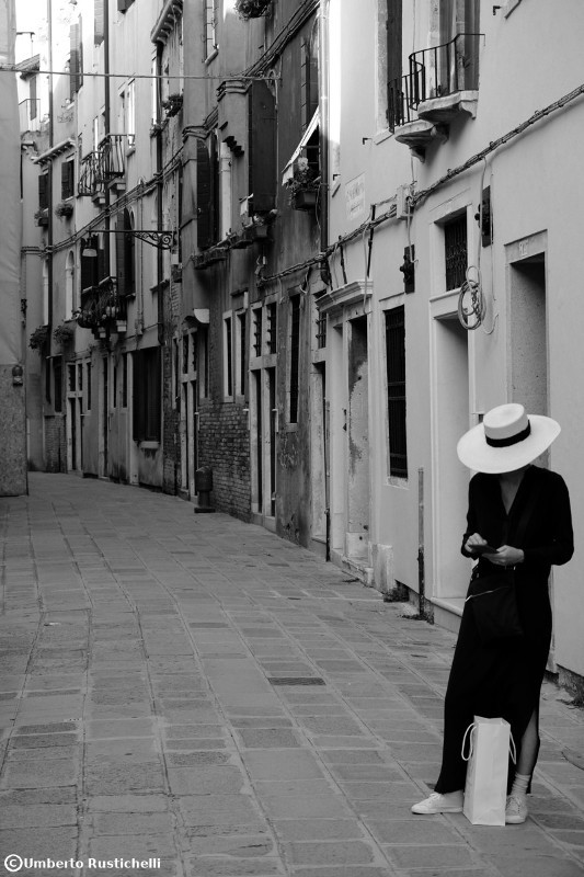 Venice, a woman in black and wait